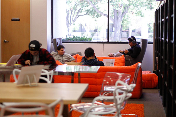 USV students relaxing and independently studying in the sunny USV library.